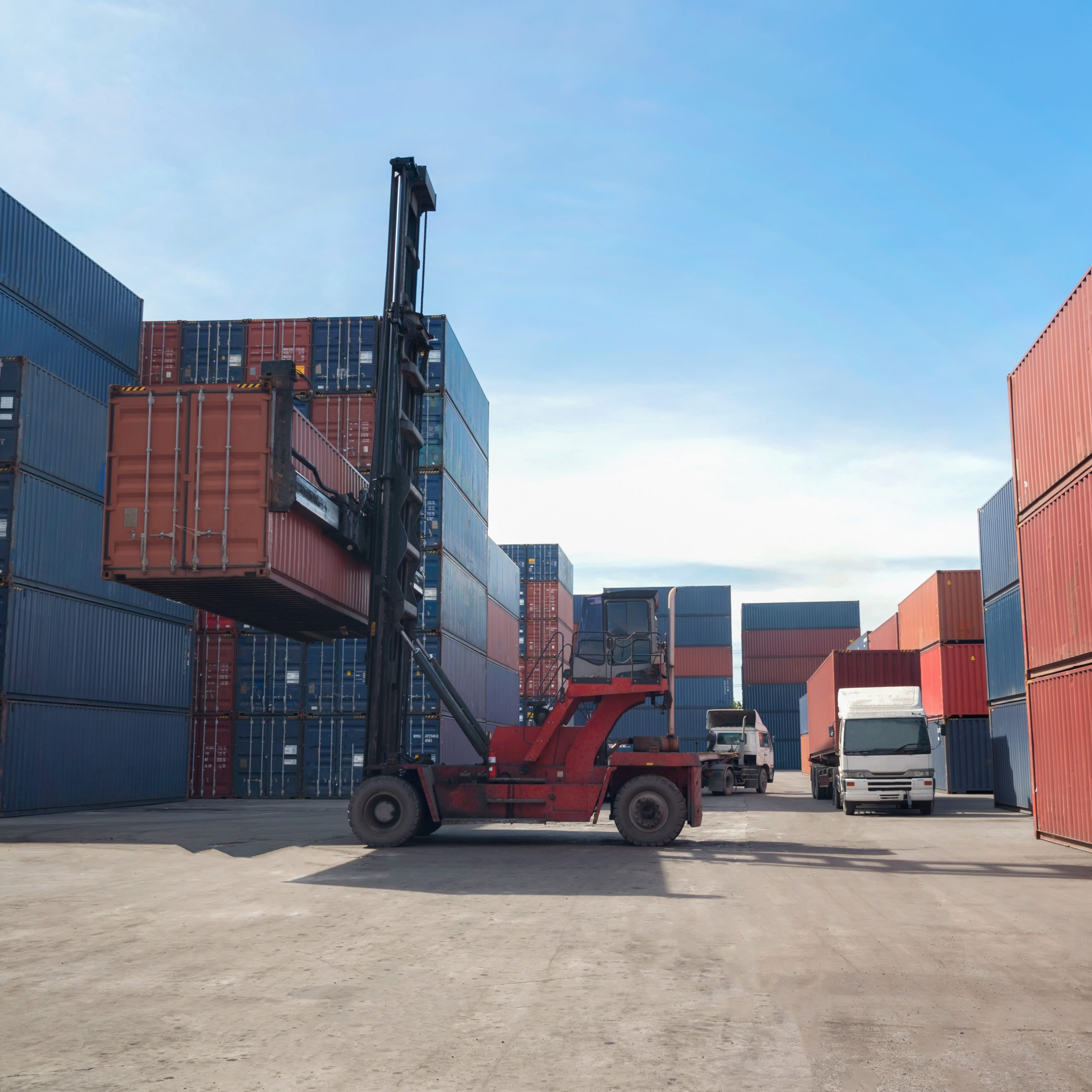 Industrial Container yard with forklift working in the morning for logistic import export background