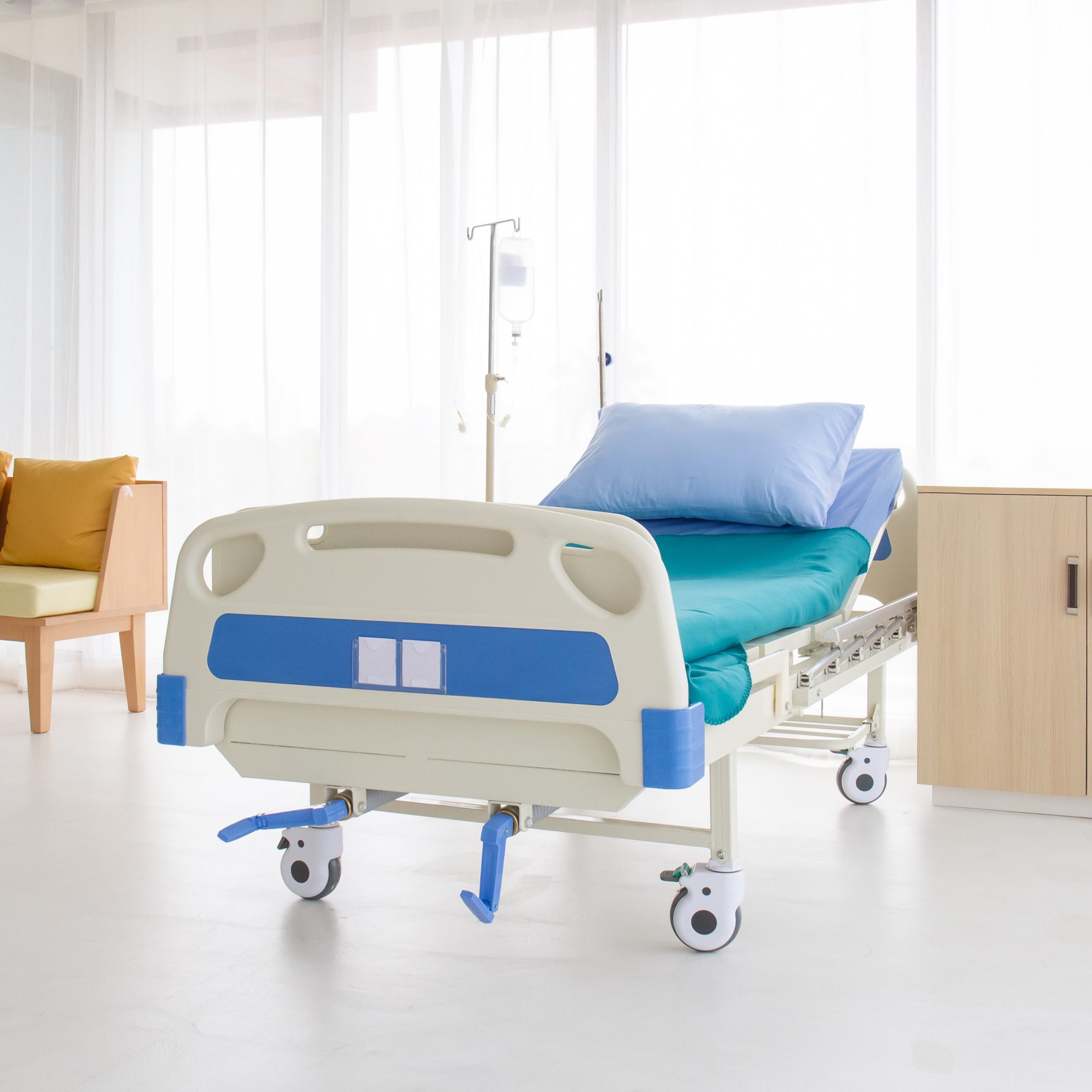 Empty bed in a hospital room.blue and white hospital bed on whit