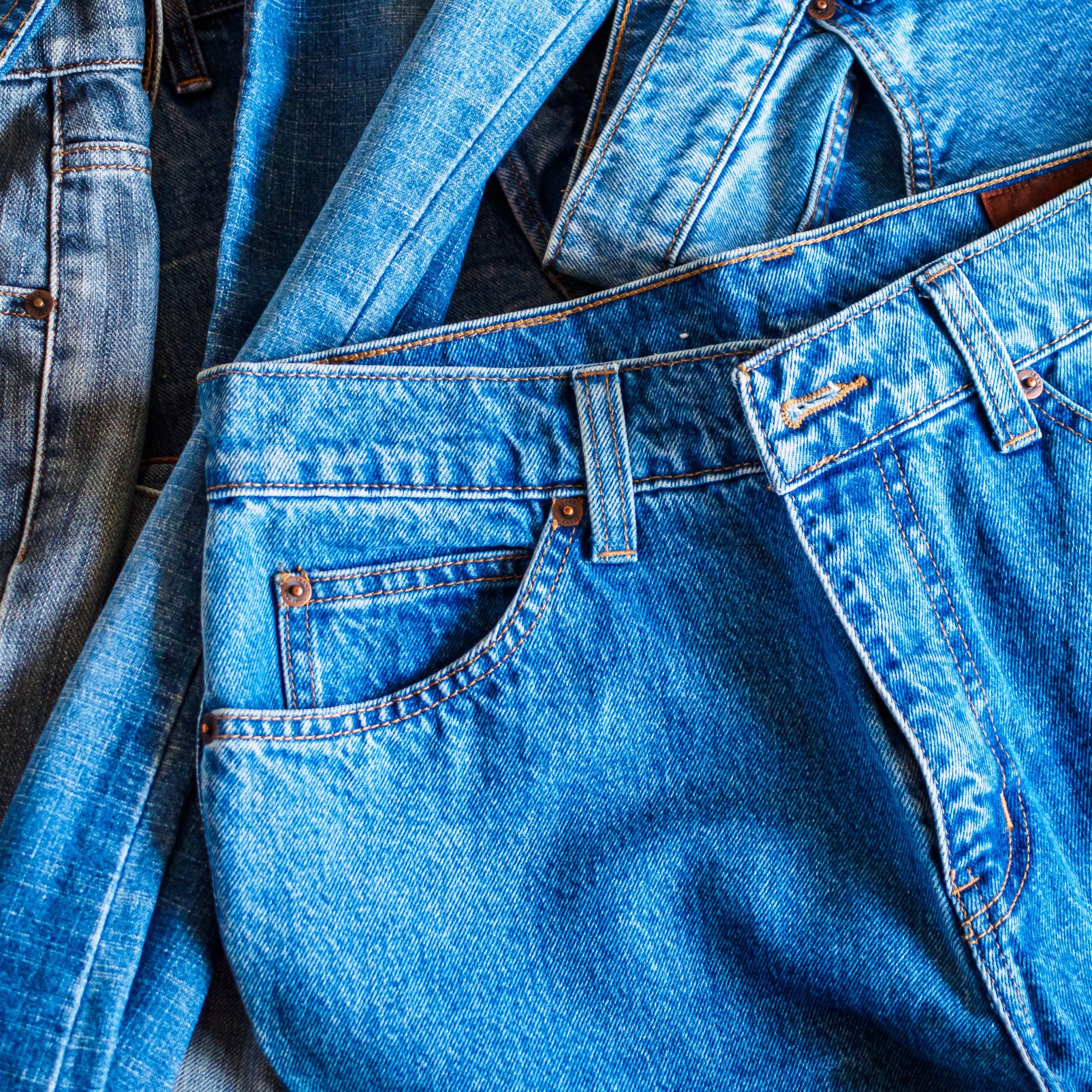 many denim blue jeans background