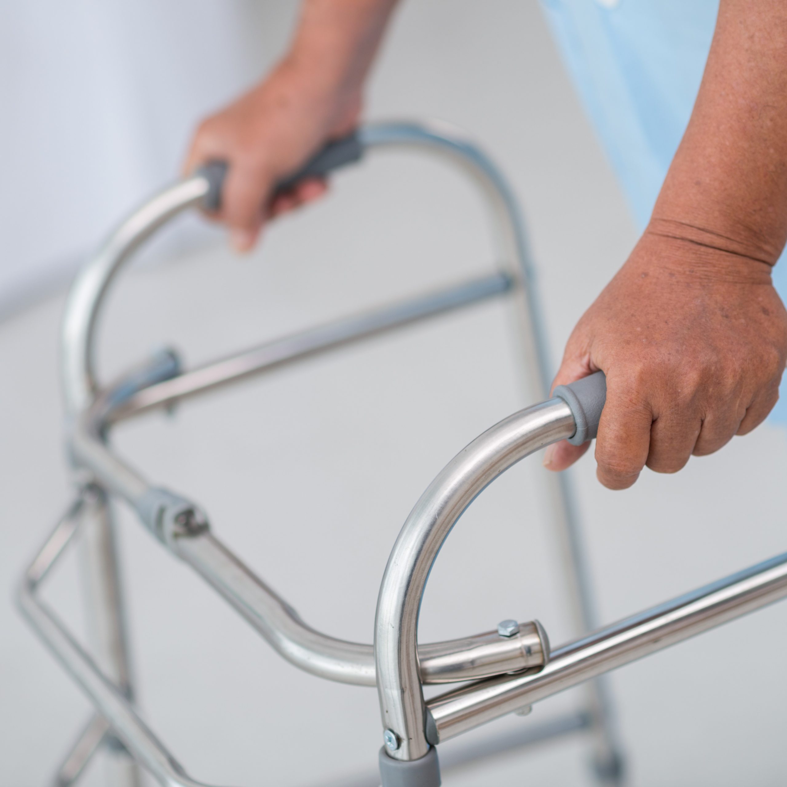 Close-up of male patient moving with walker