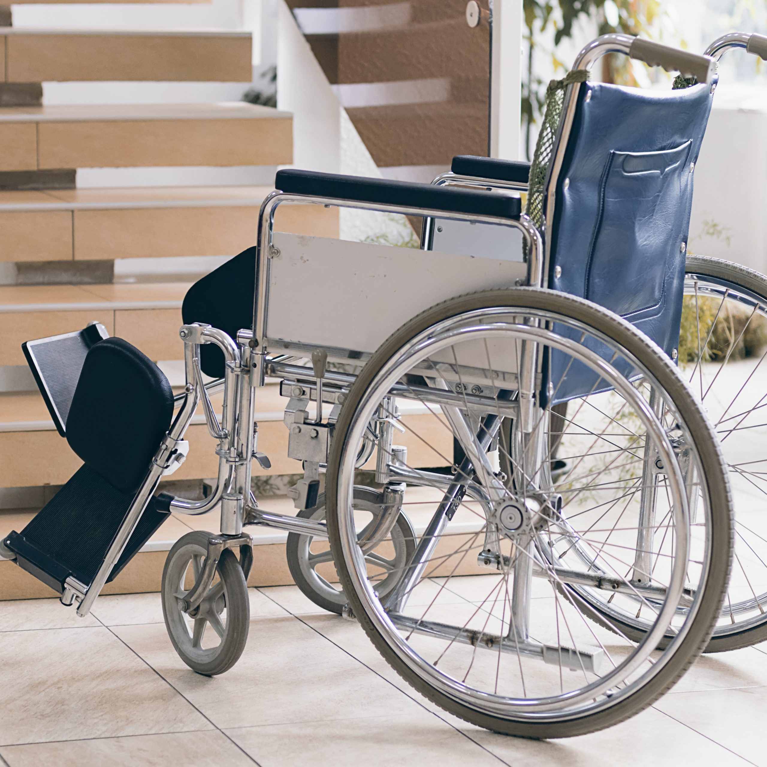 Empty wheelchair and stairs. Disabled accessibility reality.